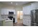 Modern kitchen featuring white cabinets, stainless steel appliances, and beautiful countertop and backsplash at 3405 Silver Glen Ct, Plant City, FL 33566