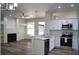 Open-concept kitchen and living area with a gas fireplace, new stainless steel appliances, and a ceiling fan at 3405 Silver Glen Ct, Plant City, FL 33566