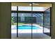 View of the backyard screened-in pool from the home's sliding glass doors at 3405 Silver Glen Ct, Plant City, FL 33566