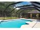 A full view of the screened-in pool and the home's exterior, surrounded by a backyard at 3405 Silver Glen Ct, Plant City, FL 33566