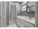 Modern bathroom featuring a glass-enclosed shower, sleek vanity, and a minimalist design at 3408 W Swann Ave, Tampa, FL 33609