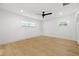 Well-lit bedroom featuring new flooring, two windows, and a modern ceiling fan at 3408 W Swann Ave, Tampa, FL 33609