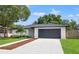 Charming single-story home with a well-manicured lawn and an attached two-car garage at 3408 W Swann Ave, Tampa, FL 33609