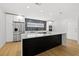 Modern kitchen features a large center island, stainless steel appliances, and sleek finishes at 3408 W Swann Ave, Tampa, FL 33609