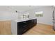 Modern kitchen features a large island with white countertops and black cabinetry at 3408 W Swann Ave, Tampa, FL 33609