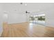 Spacious living area with sleek flooring and sliding glass doors, offering plenty of natural light at 3408 W Swann Ave, Tampa, FL 33609