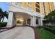 Elegant building entrance with grand archway, stately columns, and lush landscaping at 345 Bayshore Blvd # 508, Tampa, FL 33606