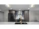 A modern kitchen featuring stainless steel appliances, white countertops, and dark cabinetry at 345 Bayshore Blvd # 508, Tampa, FL 33606