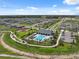 Aerial view of community pool and playground, showcasing lush landscaping and well-maintained surroundings at 34797 Rainville Loop, Zephyrhills, FL 33541