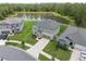 Aerial view of the home showcasing its proximity to a serene pond and beautifully landscaped surroundings at 34797 Rainville Loop, Zephyrhills, FL 33541