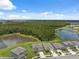 High aerial view of a neighborhood close to ponds and a wooded area at 34797 Rainville Loop, Zephyrhills, FL 33541