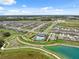 Expansive aerial view featuring a pool, walking paths, nearby ponds, and neatly planned residential development at 34797 Rainville Loop, Zephyrhills, FL 33541