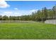 Expansive, green backyard enclosed by a white fence, perfect for outdoor activities at 34797 Rainville Loop, Zephyrhills, FL 33541