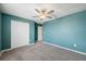 Bright bedroom featuring a ceiling fan, window, and closet at 34797 Rainville Loop, Zephyrhills, FL 33541