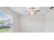 Minimalist bedroom with a ceiling fan and a window with blinds at 34797 Rainville Loop, Zephyrhills, FL 33541