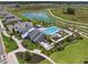 Aerial view of community pool with lounge areas and landscaping at 34797 Rainville Loop, Zephyrhills, FL 33541