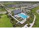 Aerial view of community pool with surrounding homes and landscaping at 34797 Rainville Loop, Zephyrhills, FL 33541