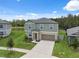 Inviting two-story home with a neutral color scheme, well-manicured lawn and two car garage at 34797 Rainville Loop, Zephyrhills, FL 33541