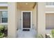 Inviting front door with a welcoming welcome mat and elegant exterior at 34797 Rainville Loop, Zephyrhills, FL 33541
