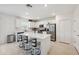 Bright kitchen featuring a large island with bar seating, modern cabinetry, and stainless appliances at 34797 Rainville Loop, Zephyrhills, FL 33541