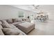 Bright and open living space with a comfortable sectional and views of the kitchen at 34797 Rainville Loop, Zephyrhills, FL 33541