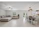 Spacious open-concept living room featuring tile floors and a cozy sectional sofa at 34797 Rainville Loop, Zephyrhills, FL 33541