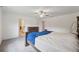 Spacious main bedroom features a ceiling fan, neutral carpet, and dark wood furniture at 34797 Rainville Loop, Zephyrhills, FL 33541
