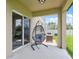 Covered patio area featuring a hanging chair and outdoor seating set at 34797 Rainville Loop, Zephyrhills, FL 33541