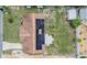 Aerial view shows solar panels, backyard and layout of the home at 3818 Beechwood Dr, Holiday, FL 34691