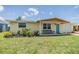 Charming single-story home with a well-manicured front yard and bright blue door at 3818 Beechwood Dr, Holiday, FL 34691