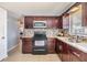Modern kitchen with stainless steel sink, updated cabinets, and tile backsplash at 3818 Beechwood Dr, Holiday, FL 34691