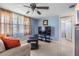 Comfortable living room featuring a ceiling fan and a large window for natural light at 3818 Beechwood Dr, Holiday, FL 34691