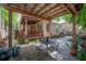 Inviting backyard with brick patio, covered seating area, and lush landscaping at 409 E Frances Ave, Tampa, FL 33602