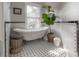 Bright bathroom featuring a claw foot tub, and decorative tile flooring at 409 E Frances Ave, Tampa, FL 33602