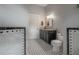 A bathroom featuring a granite countertop vanity, black and white tile floor and a door to the Primary at 409 E Frances Ave, Tampa, FL 33602