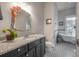 Elegant bathroom featuring a marble countertop, dark cabinetry, decorative mirror and a separate tub area at 409 E Frances Ave, Tampa, FL 33602