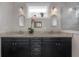 Bright bathroom features a double sink vanity, modern fixtures, and an orchid, exuding a spa-like ambiance at 409 E Frances Ave, Tampa, FL 33602