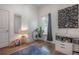 Well-lit bedroom featuring a light wood floor, area rug, changing station and window with lots of light at 409 E Frances Ave, Tampa, FL 33602