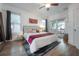 Bedroom featuring a king bed, decorative tapestry, with natural light from two windows and a french door at 409 E Frances Ave, Tampa, FL 33602