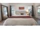 Bedroom featuring a king bed, decorative tapestry, with natural light from two windows and a french door at 409 E Frances Ave, Tampa, FL 33602
