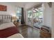 Bedroom featuring a king bed with access to an outdoor deck with seating and a ceiling fan at 409 E Frances Ave, Tampa, FL 33602