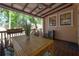 Cozy outdoor deck featuring a dining table, ceiling fan, and pleasant view with lush greenery at 409 E Frances Ave, Tampa, FL 33602