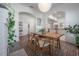 Bright dining area with hardwood floors, modern lighting, and open access to kitchen at 409 E Frances Ave, Tampa, FL 33602
