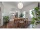 Open dining area with hardwood floors and natural lighting; view into modern kitchen at 409 E Frances Ave, Tampa, FL 33602