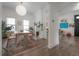 Open dining room featuring an exposed brick fireplace, hardwood floors, and modern light fixture at 409 E Frances Ave, Tampa, FL 33602