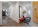 Hallway features wood floors, hall tree, bench, a large mirror, and doorway to other rooms at 409 E Frances Ave, Tampa, FL 33602