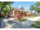 Charming home with a covered front porch, manicured landscaping, and a welcoming curb appeal at 409 E Frances Ave, Tampa, FL 33602