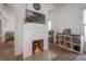 Bright living room showcasing a white brick fireplace, decorative items and hardwood floors at 409 E Frances Ave, Tampa, FL 33602