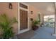 Close-up of paneled front door with modern number and door furniture, and a cozy porch swing at 409 E Frances Ave, Tampa, FL 33602