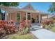 Charming single-story home with a welcoming front porch and beautifully landscaped front yard at 409 E Frances Ave, Tampa, FL 33602